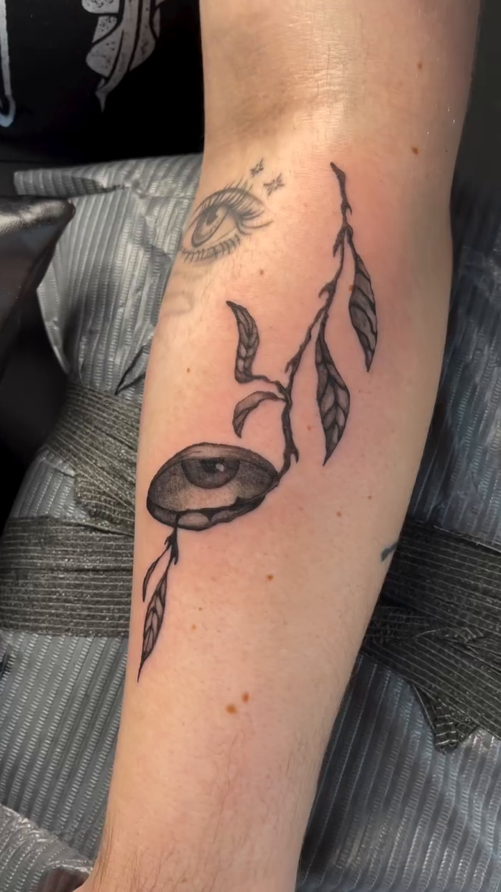 Eye with branches and leaves dotwork tattoo on the forearm by Amy