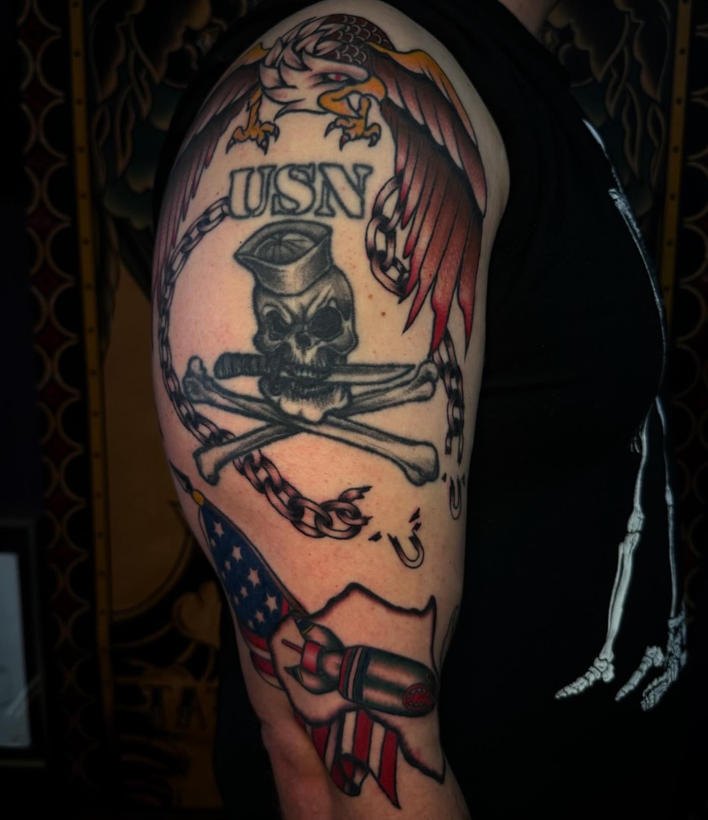 USN skull and crossbones American traditional tattoo on the upper arm by Lydia