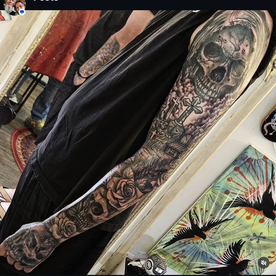 Skull, graveyard, and roses sleeve realism tattoo on the forearm by Shane Watkins