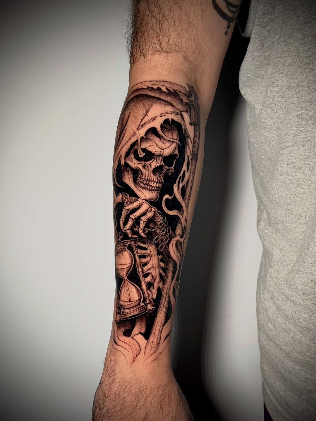 Grim reaper with hourglass realism tattoo on the forearm by Kbtattz