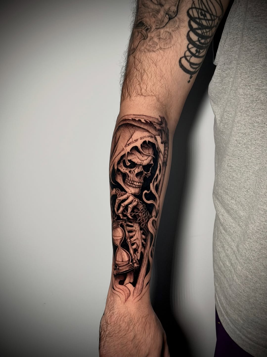 Grim reaper with hourglass realism tattoo on the forearm by Kbtattz