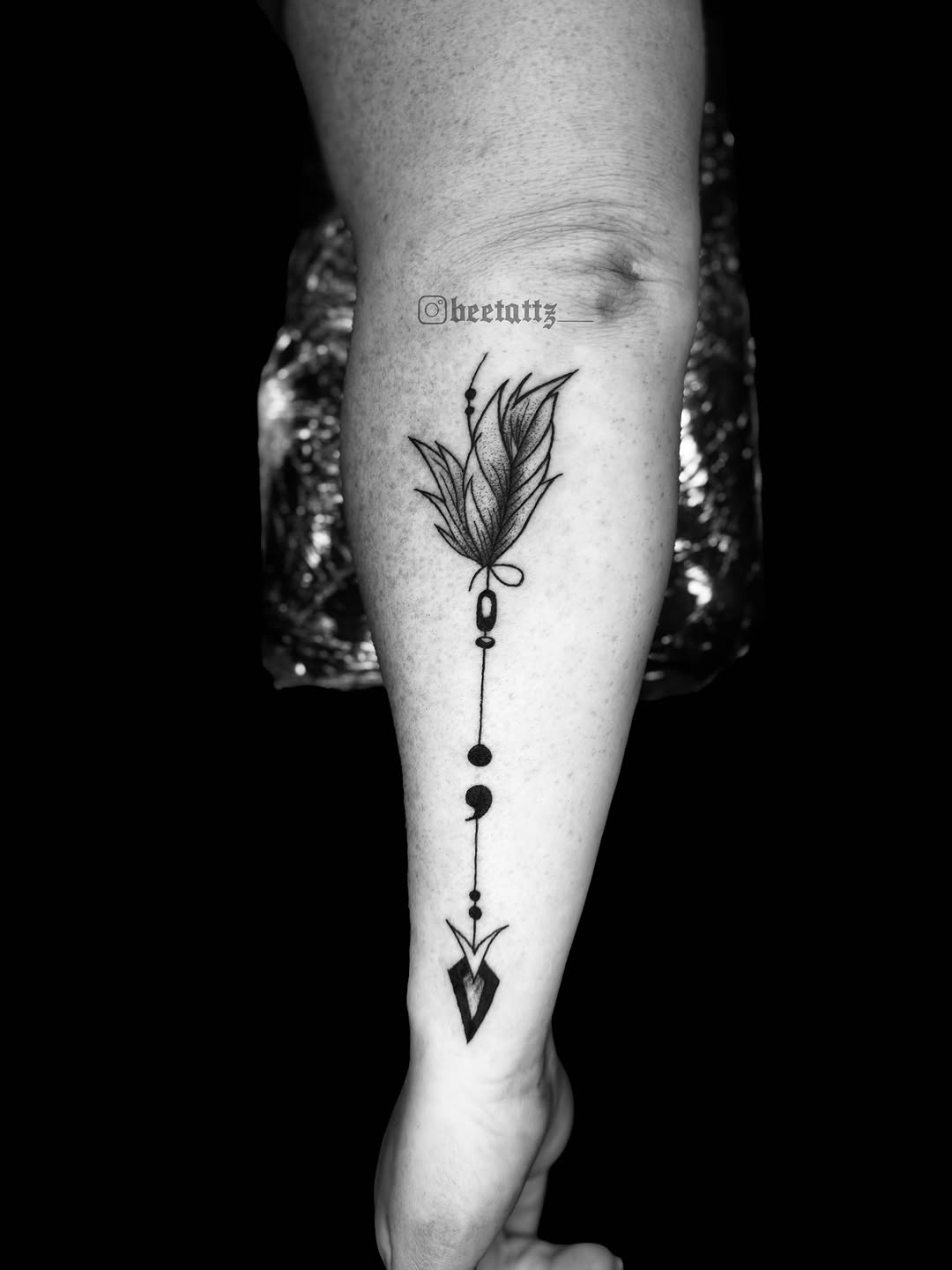 Feather and arrow tattoo on the forearm by Brinkley McGill