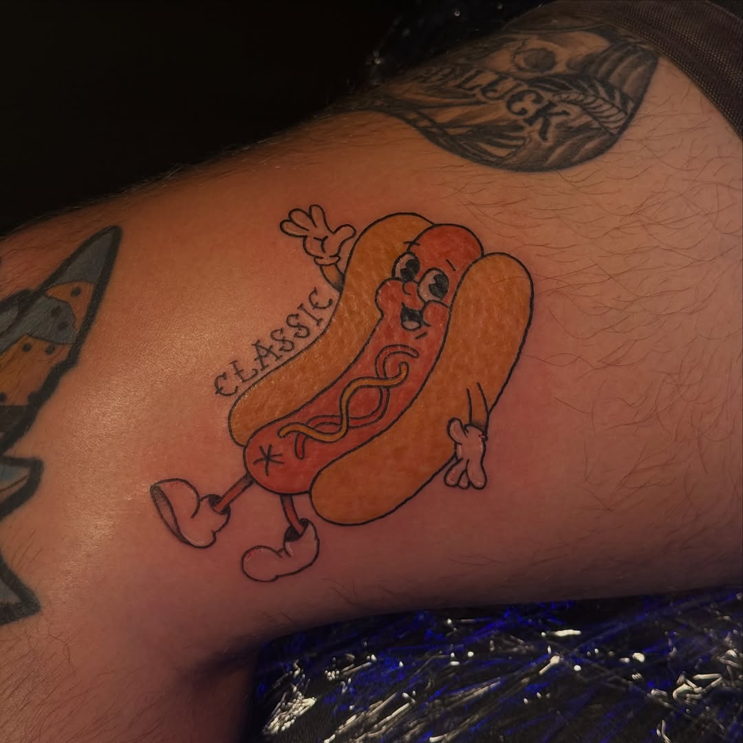 Cartoon hot dog new school tattoo on the forearm by licensed charlotte tattoo artist