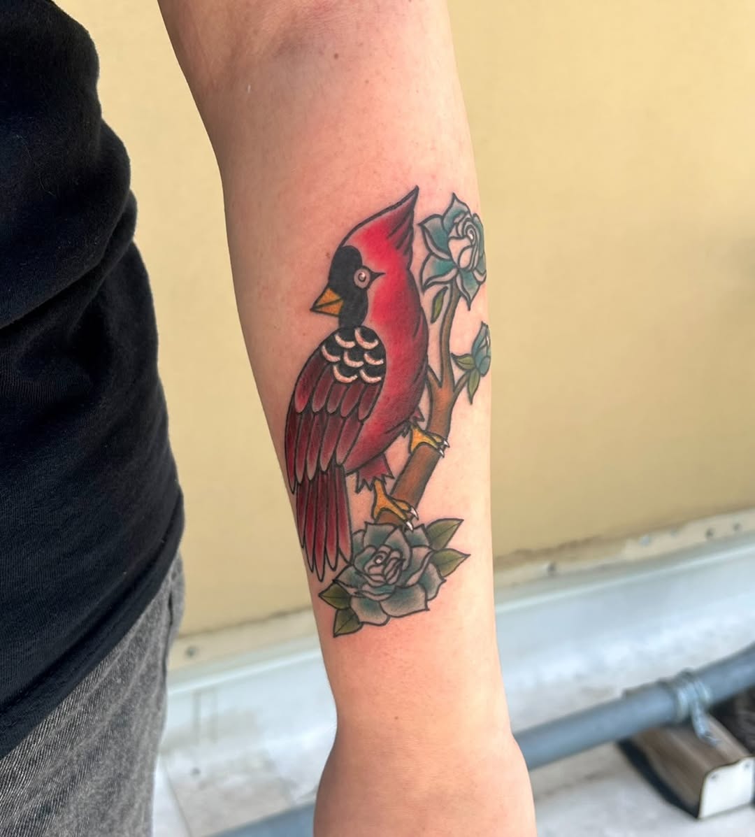 Cardinal on a branch with roses neo-traditional tattoo on the forearm by ๐ Michelle ๐