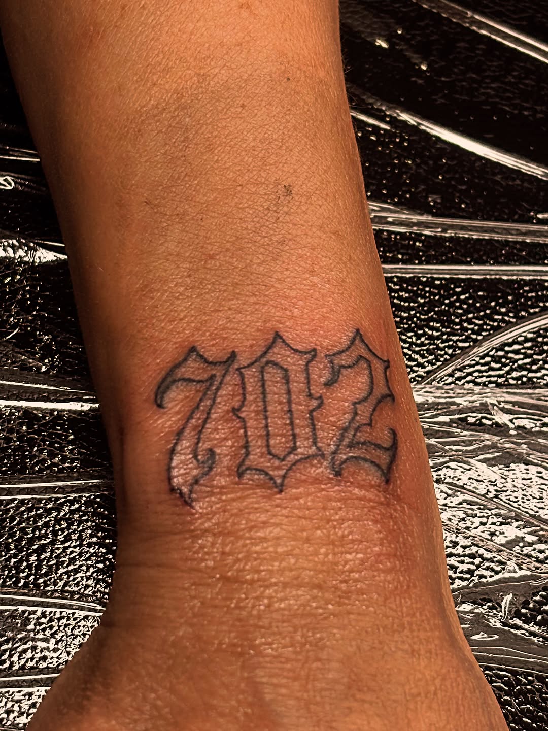 Numbers 702 tattoo on the forearm by Las Vegas Tattoo Artist ๐ฒโ๏ธ