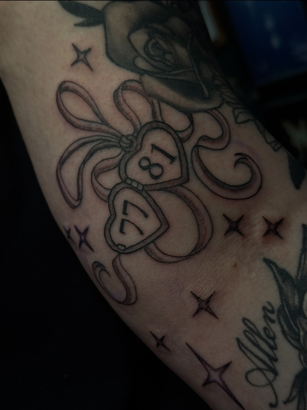 Bow and ribbon black and grey tattoo on the forearm by jess jené jones, Portland, Oregon