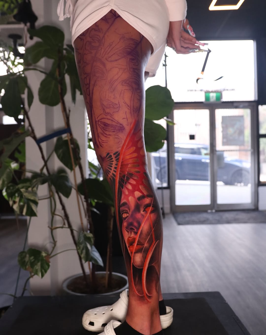 Woman's face with abstract elements neo-traditional tattoo on the leg by Naomi Burke, New Westminster, British Columbia