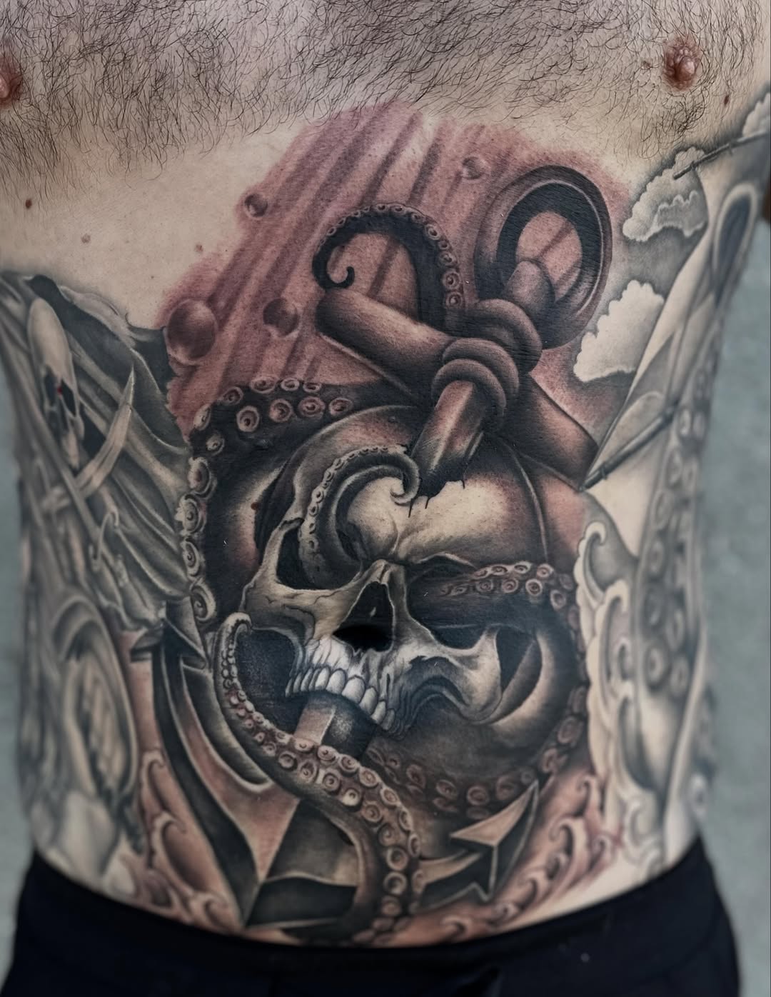 Skull and octopus with anchor realism tattoo on the torso by Ruben