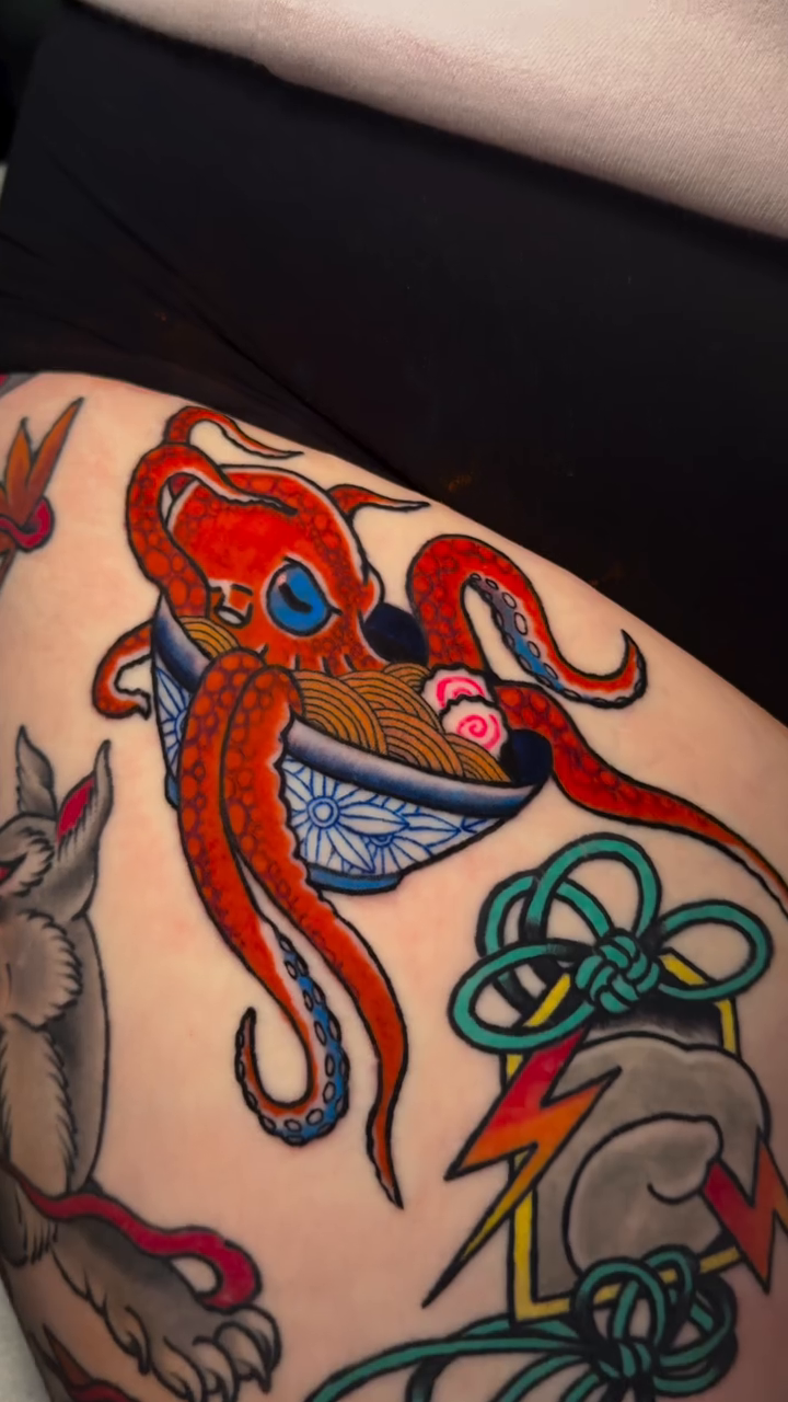 Octopus in a bowl of ramen American traditional tattoo on the thigh by Mercy Dean