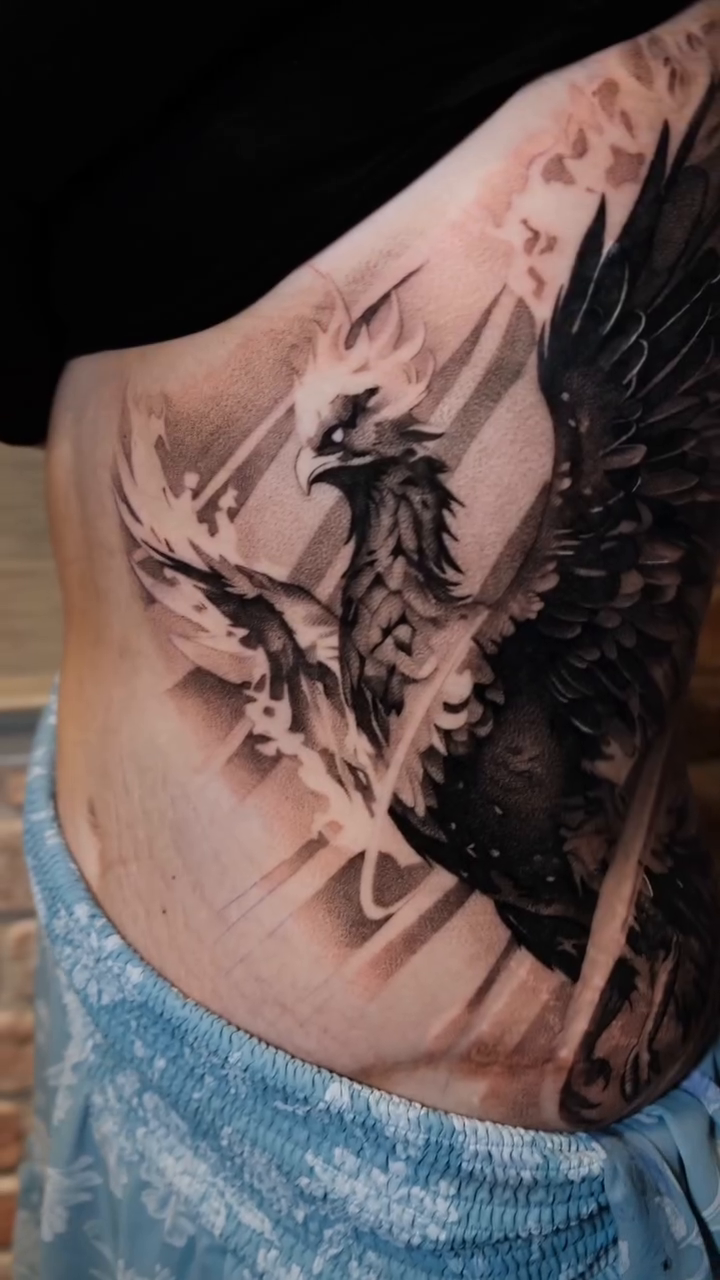 Phoenix tattoo on torso realism tattoo on the upper arm by Ana Fajardo