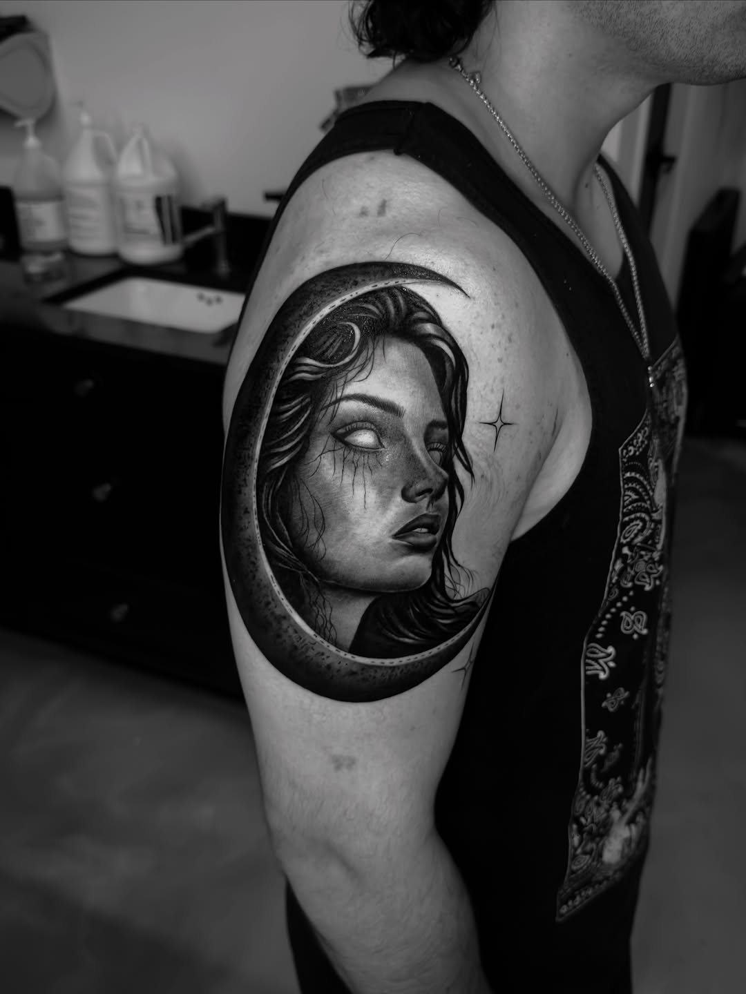 Woman in moon realism tattoo on the shoulder by Brandon Patino