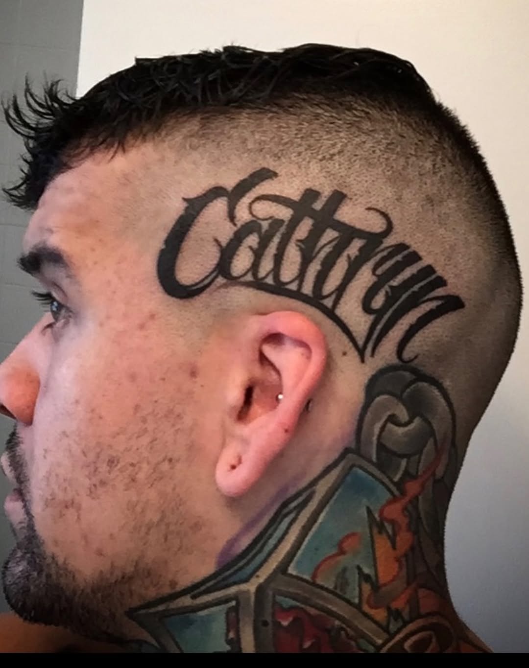 Script lettering 'Cathryn' lettering tattoo on the head by James ⚡️ Tattoo Artist