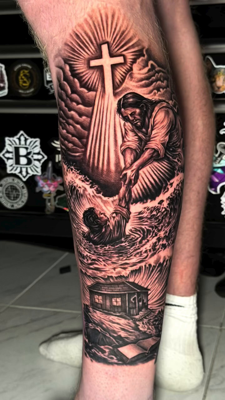 Jesus saving a drowning man realism tattoo by professional tattoo artist
