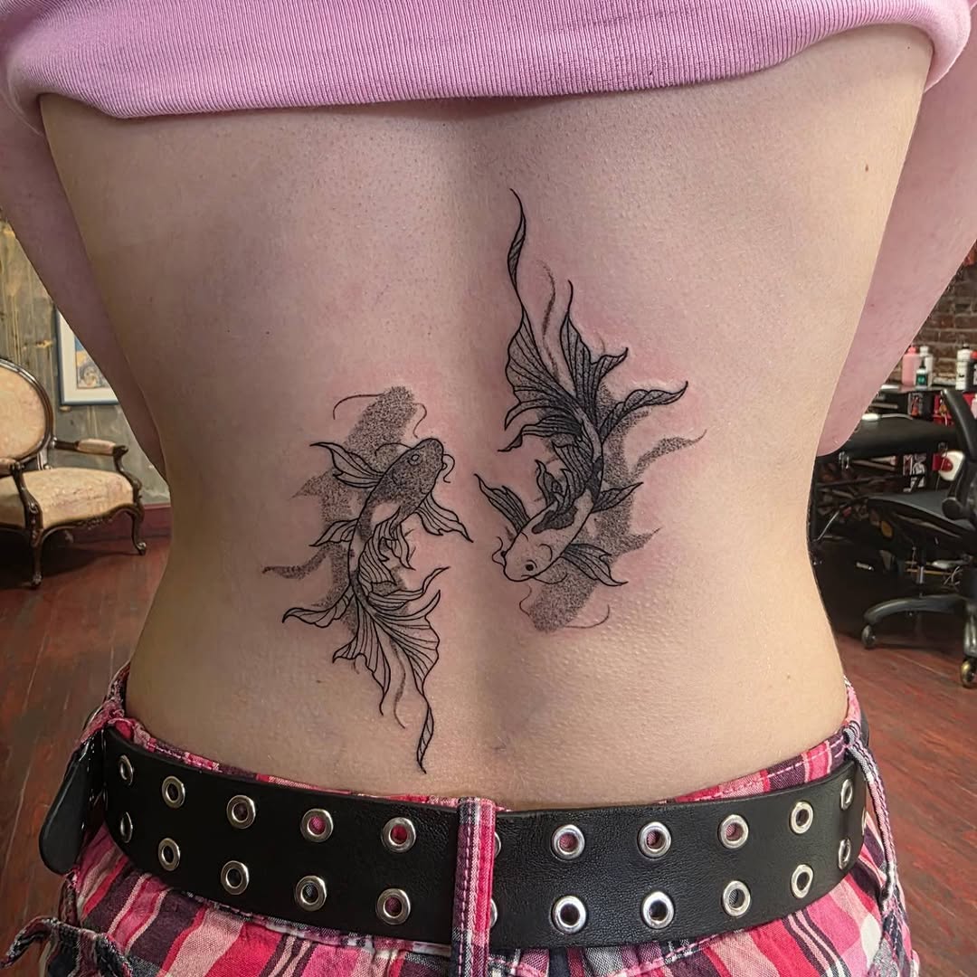Two koi fish blackwork tattoo on the ribs by Tattoos by Annie