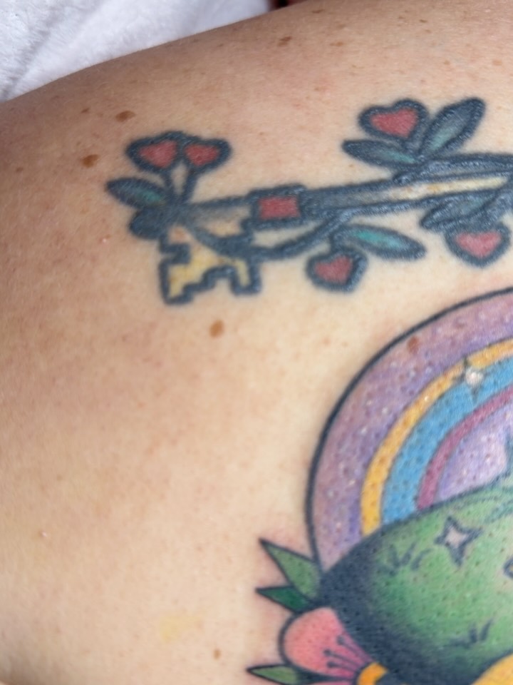 Branch with hearts and key American traditional tattoo on the shoulder by Natalie