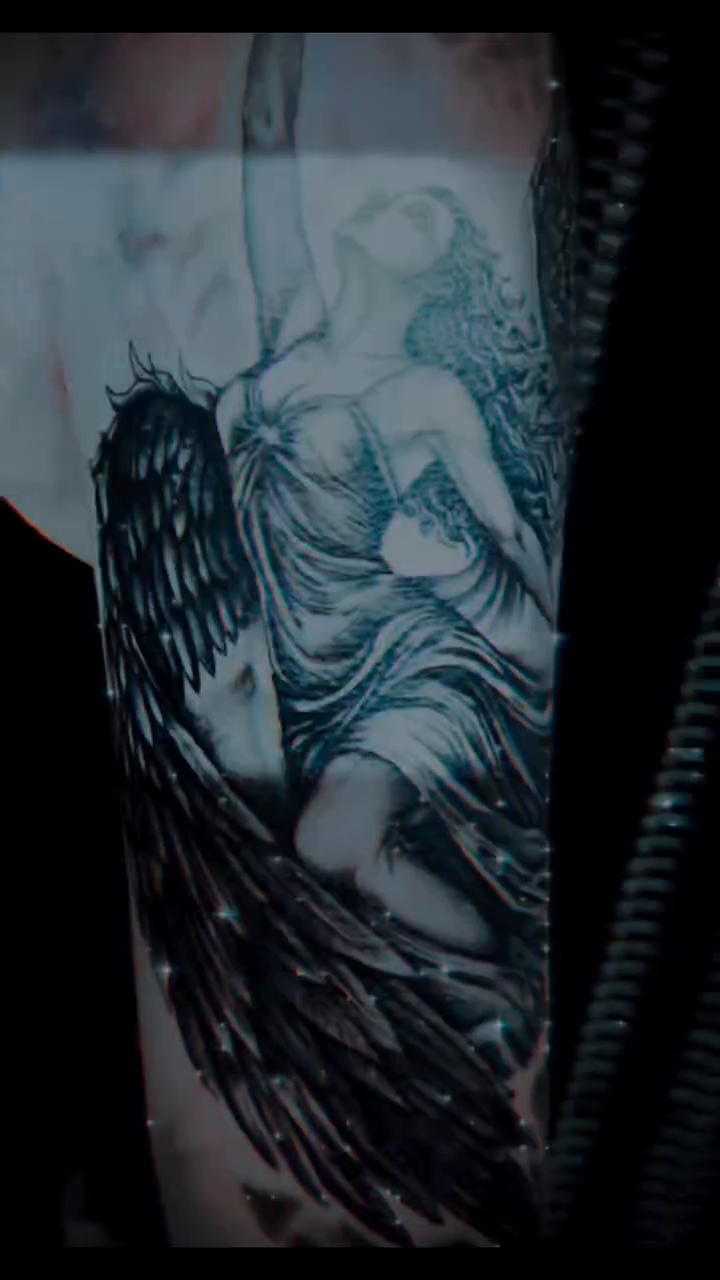 Angel with wings and skull realism tattoo on the upper arm by Tattoos by Dan Hatcher Carr, Parma, Ohio