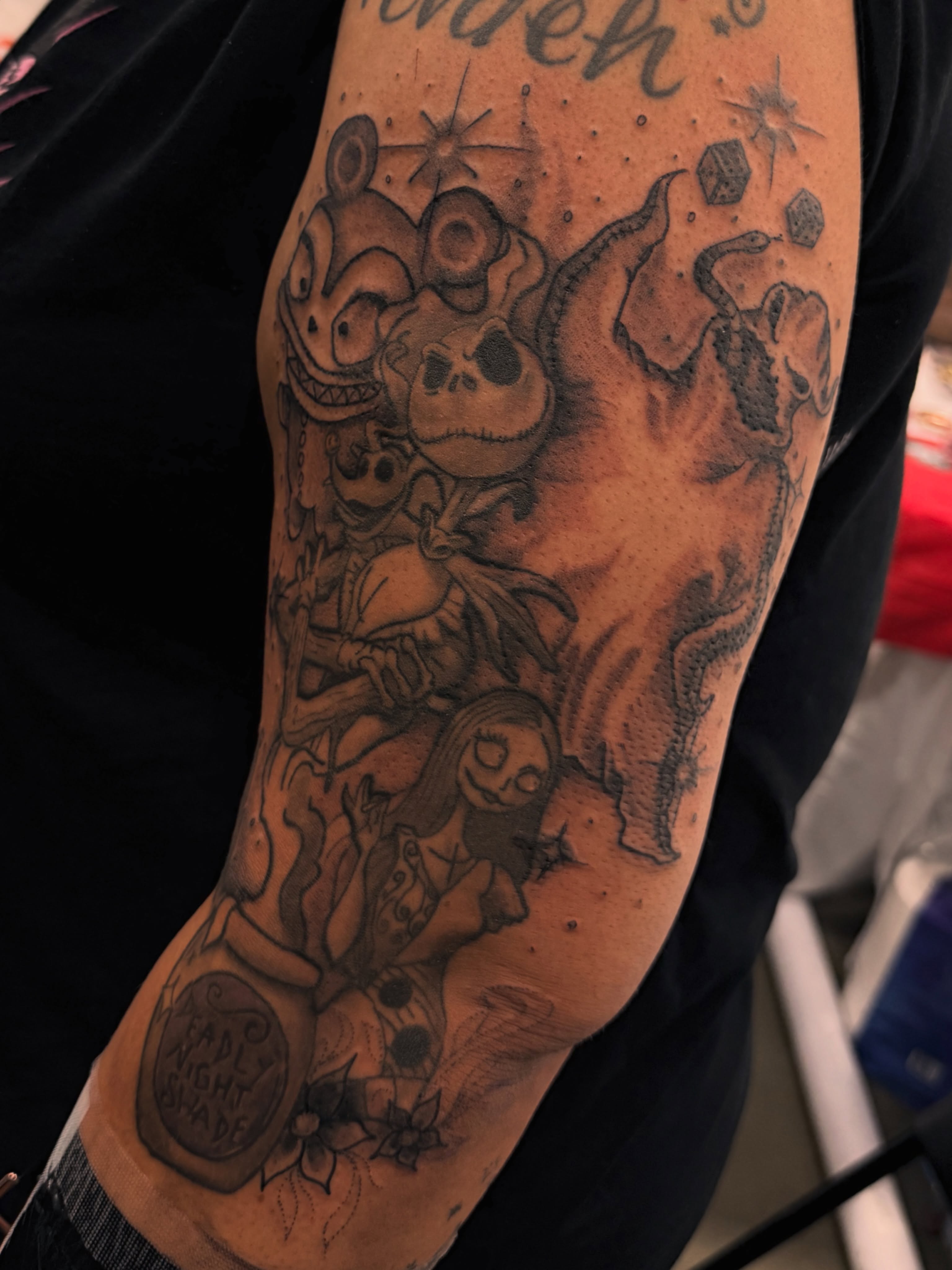 Nightmare Before Christmas characters black and grey tattoo on the forearm by Juan Pablo
