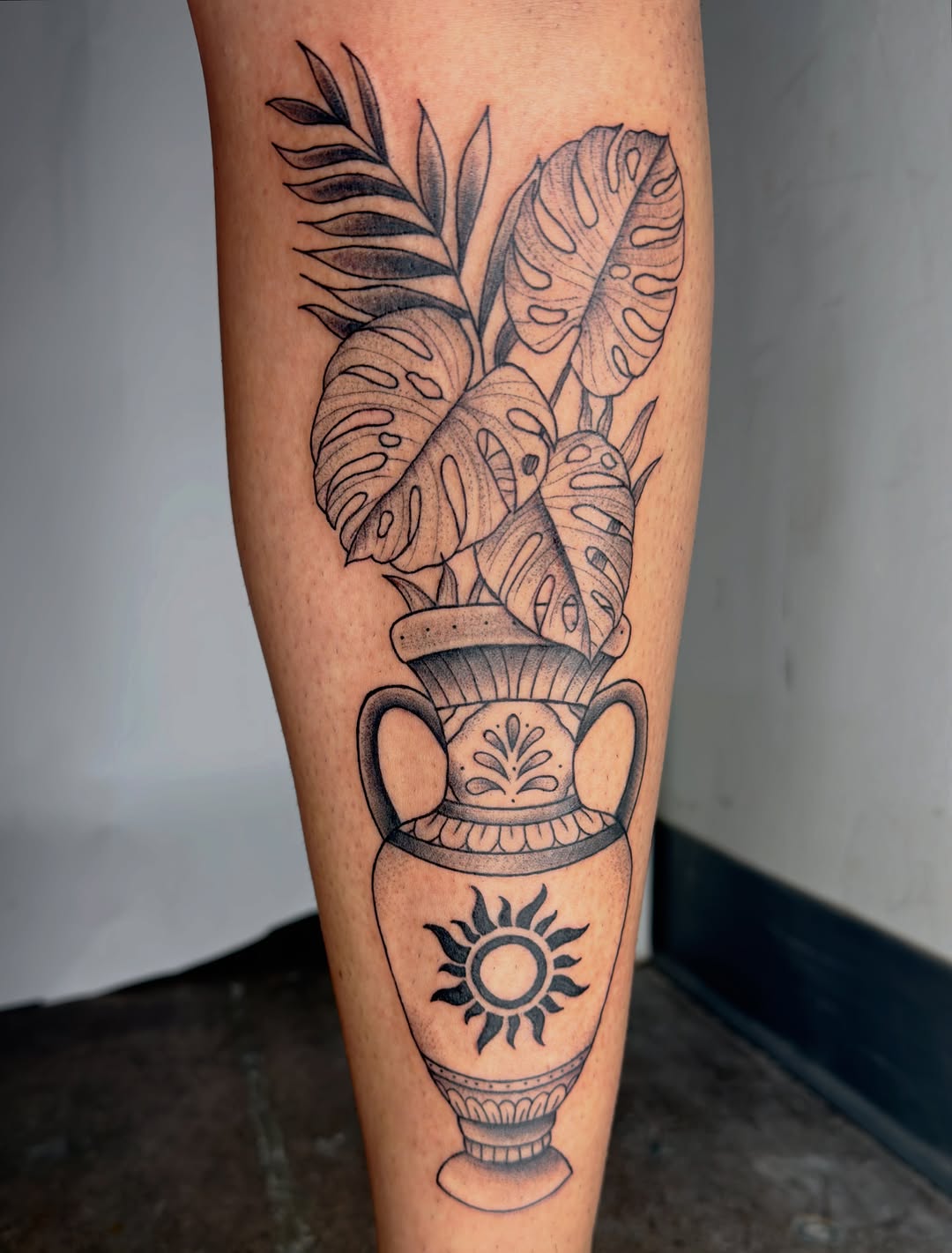 Vase with plants and sun surrealism tattoo on the forearm by Charlotte (Luna), Seattle, Washington