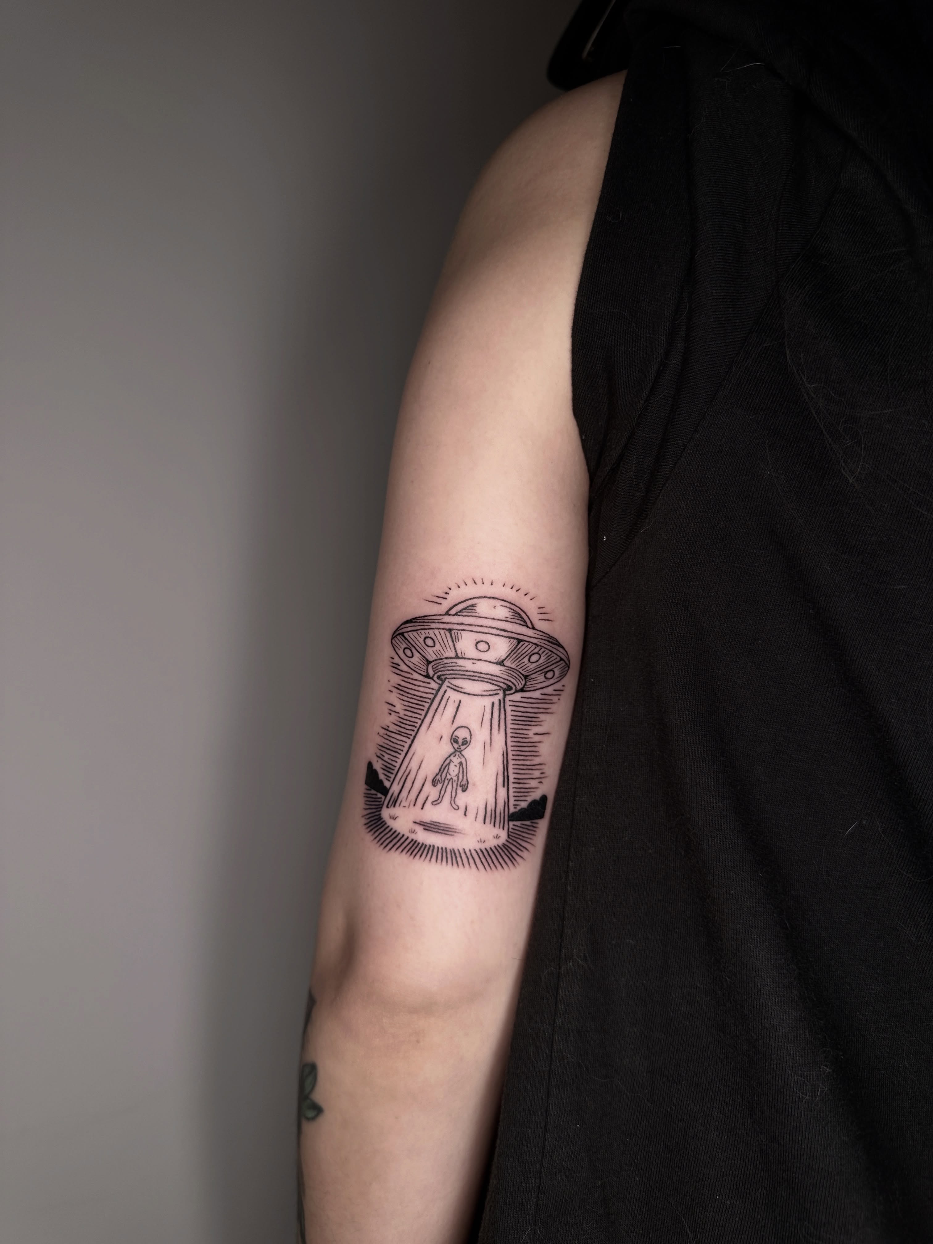 Alien abduction black and grey tattoo on the forearm by Zecember