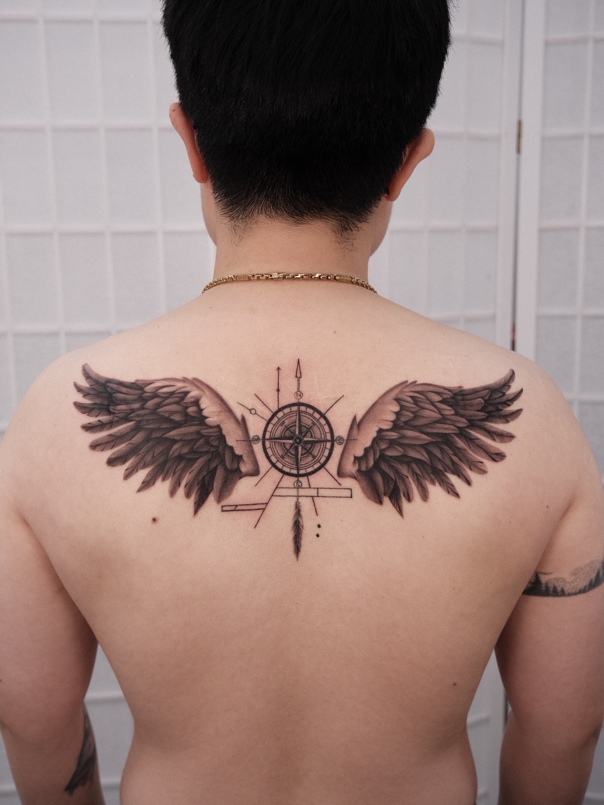 Wings and compass geometric tattoo on the back by Houston Tattoo Artist GoldenK
