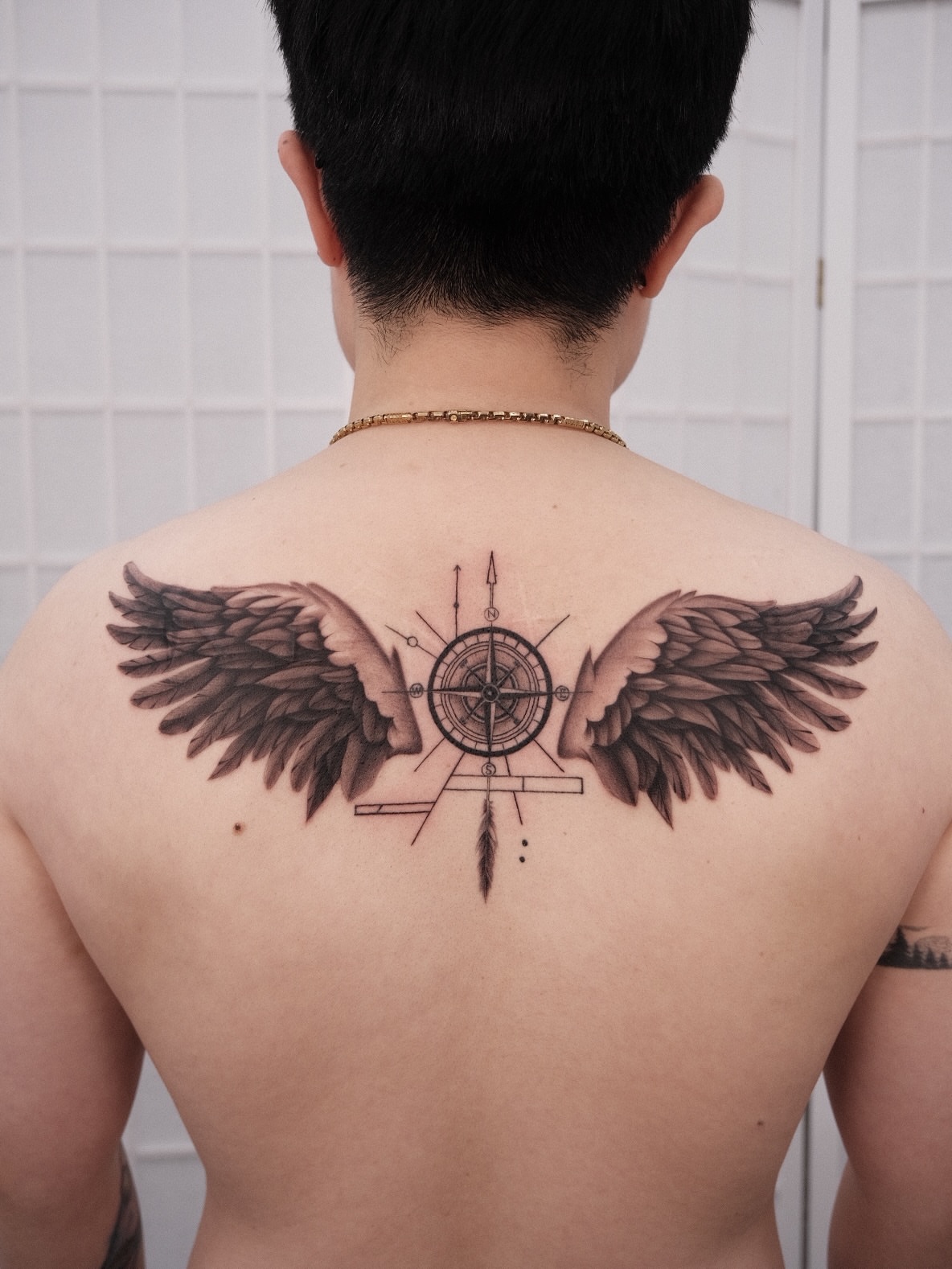 Wings and compass geometric tattoo on the back by Houston Tattoo Artist GoldenK