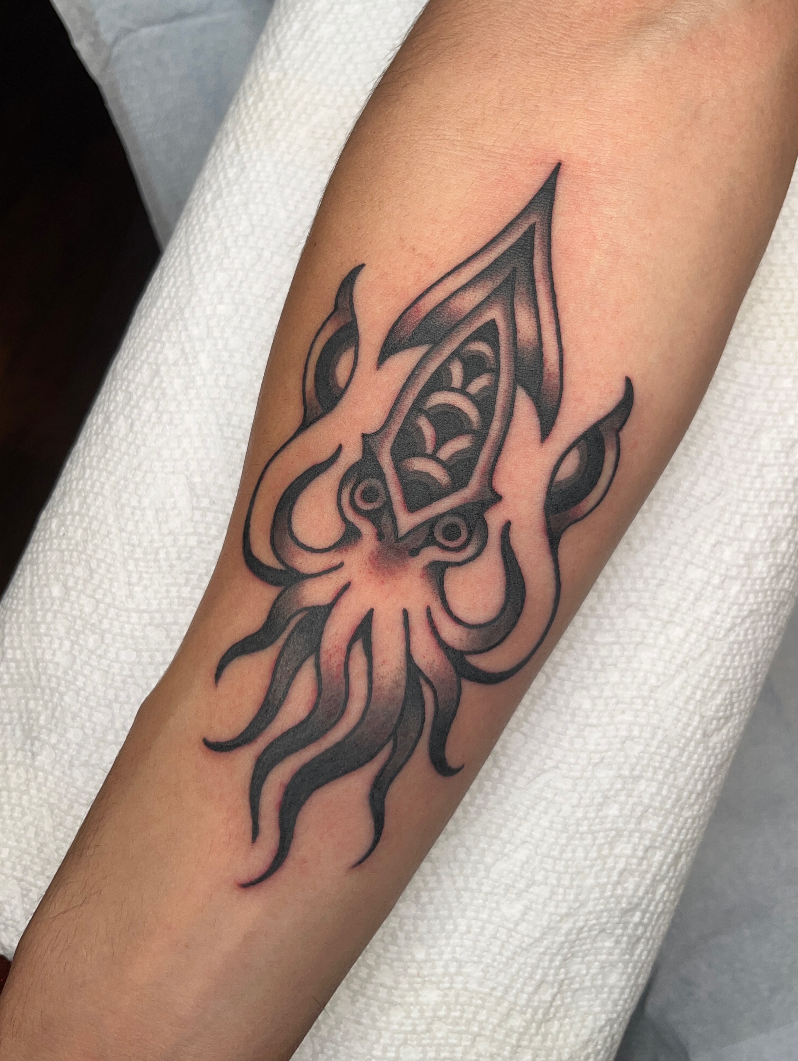 Squid tribal tattoo on the forearm by Nat Power