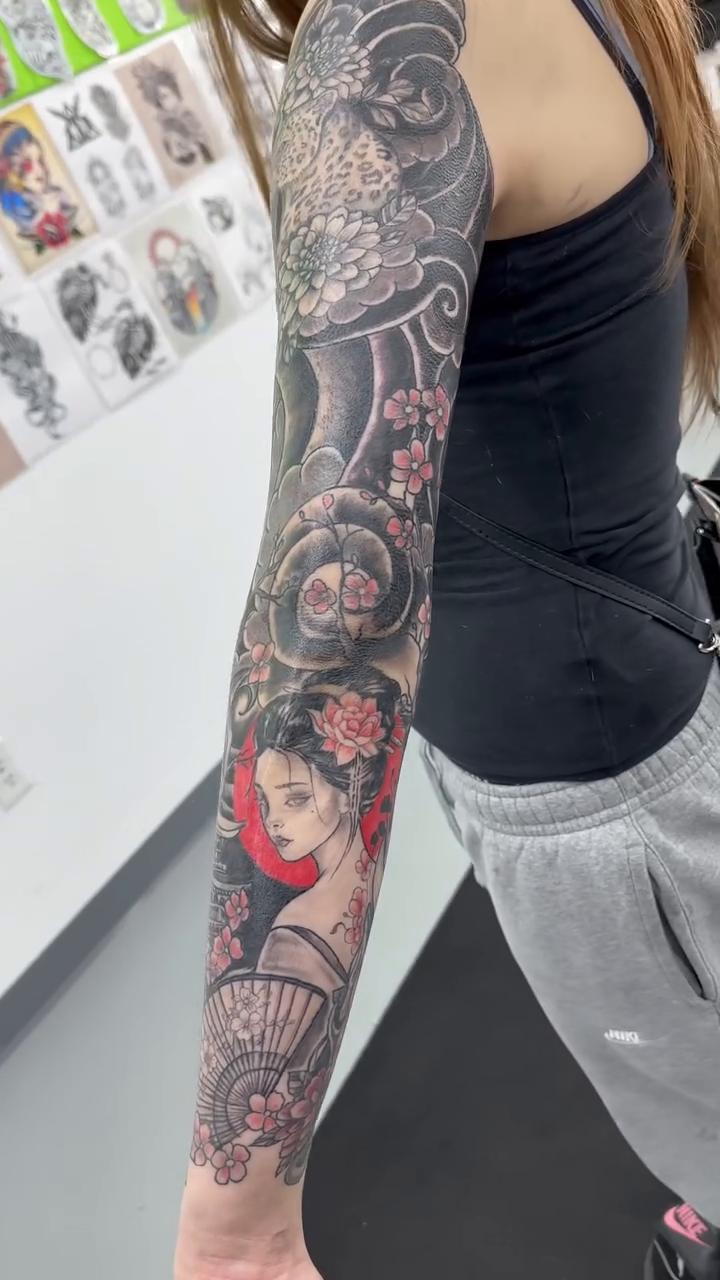 Full sleeve with geisha and dragon Japanese tattoo on the upper arm by Brian Lambert