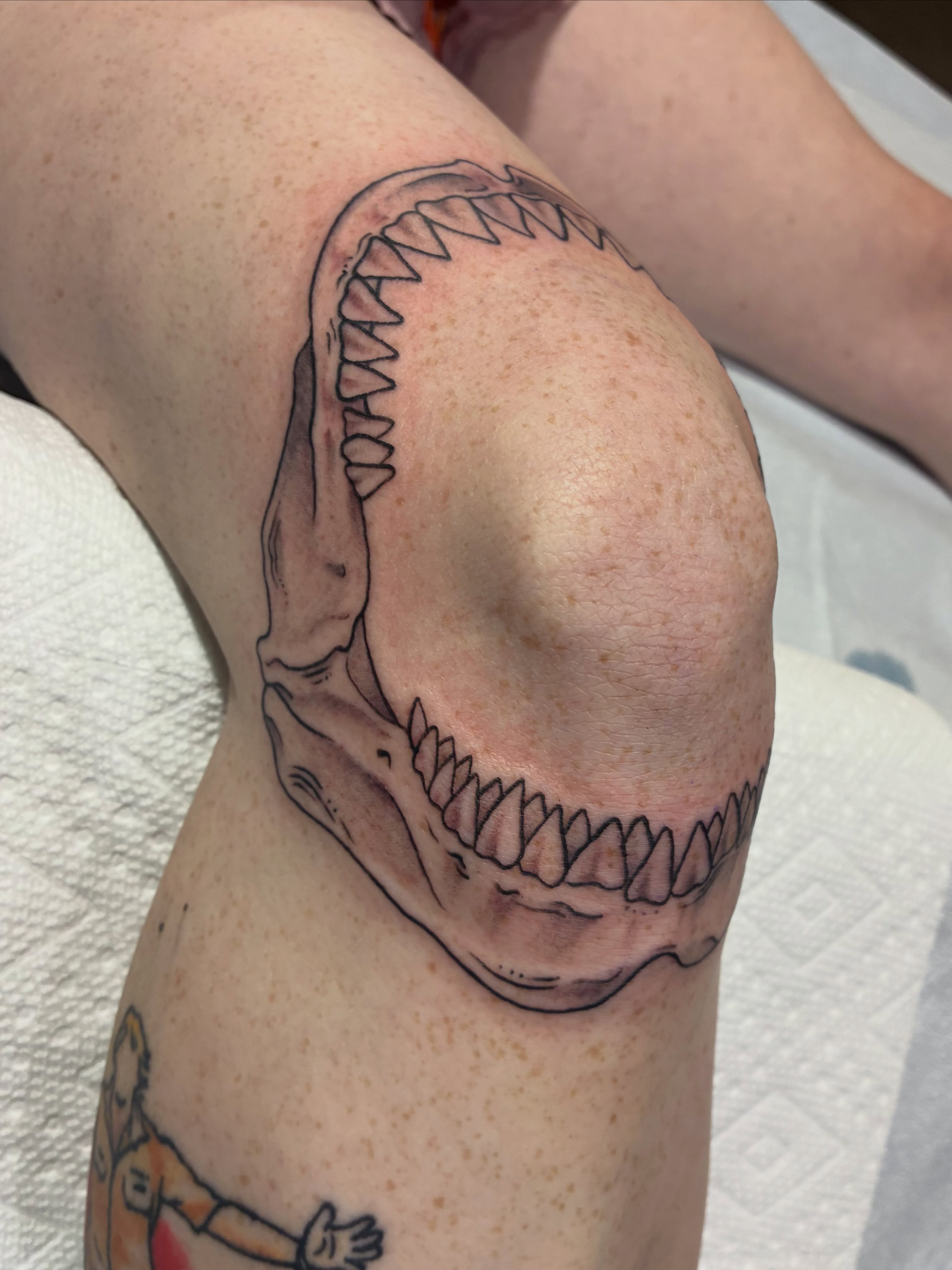 Dinosaur skull realism tattoo on the upper arm by Natalie Spuhler