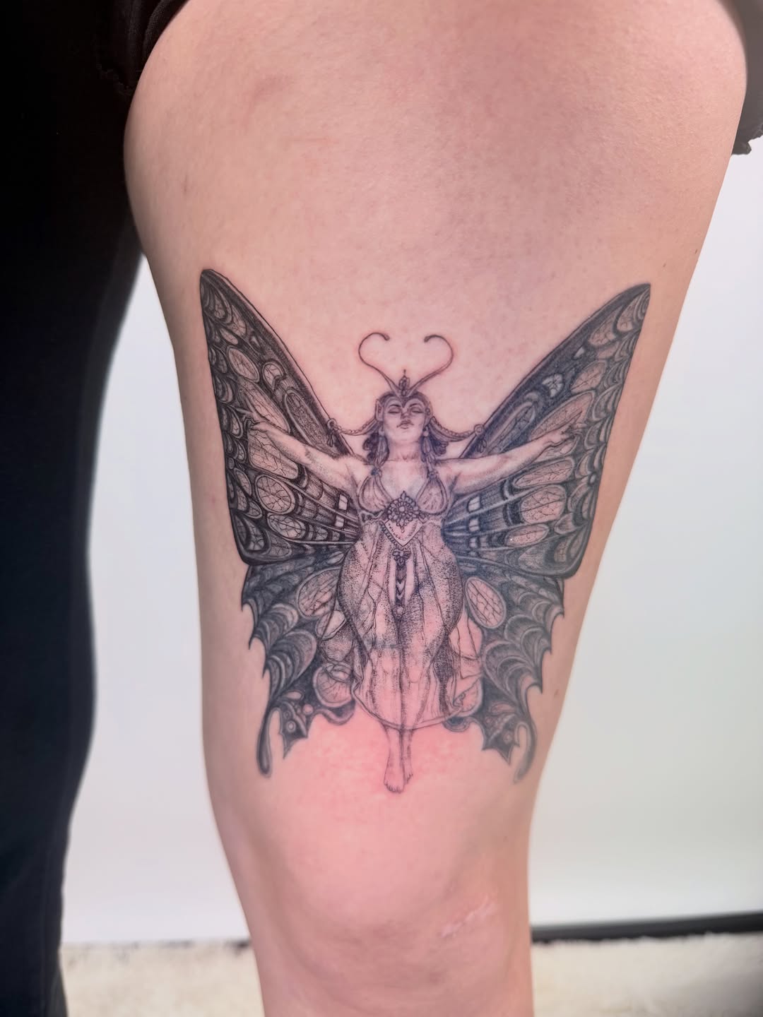 Woman with butterfly wings fine line tattoo on the thigh by Yuri Chloe Ngo Tattoo Artist