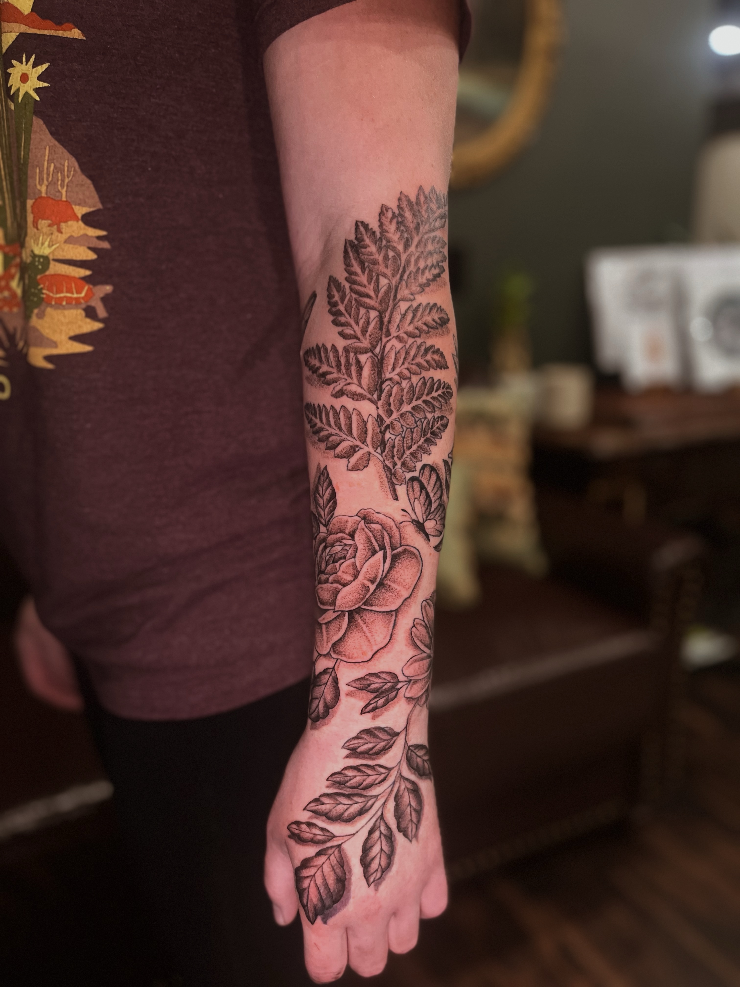 Floral design black and grey tattoo on the forearm by Lily Nurnberger
