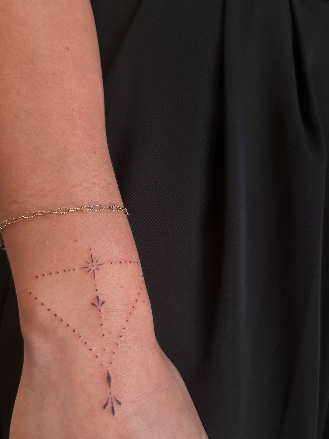 Geometric constellation ornamental tattoo on the forearm by Fineline Tattoos DFW