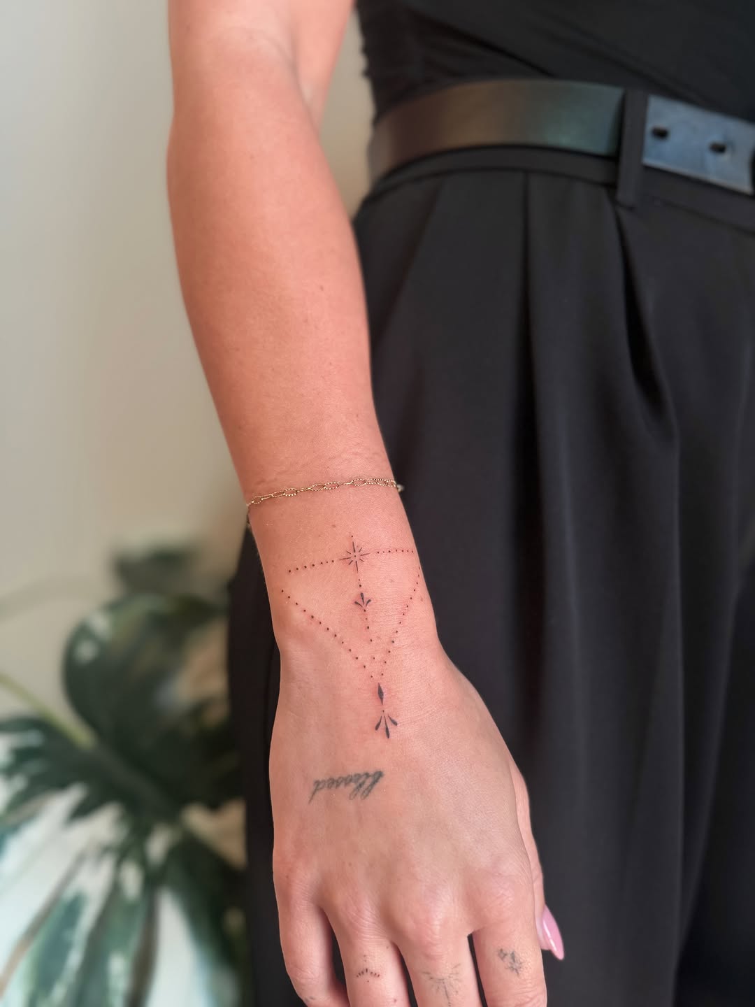 Geometric constellation with script ornamental tattoo on the forearm by Fineline Tattoos DFW