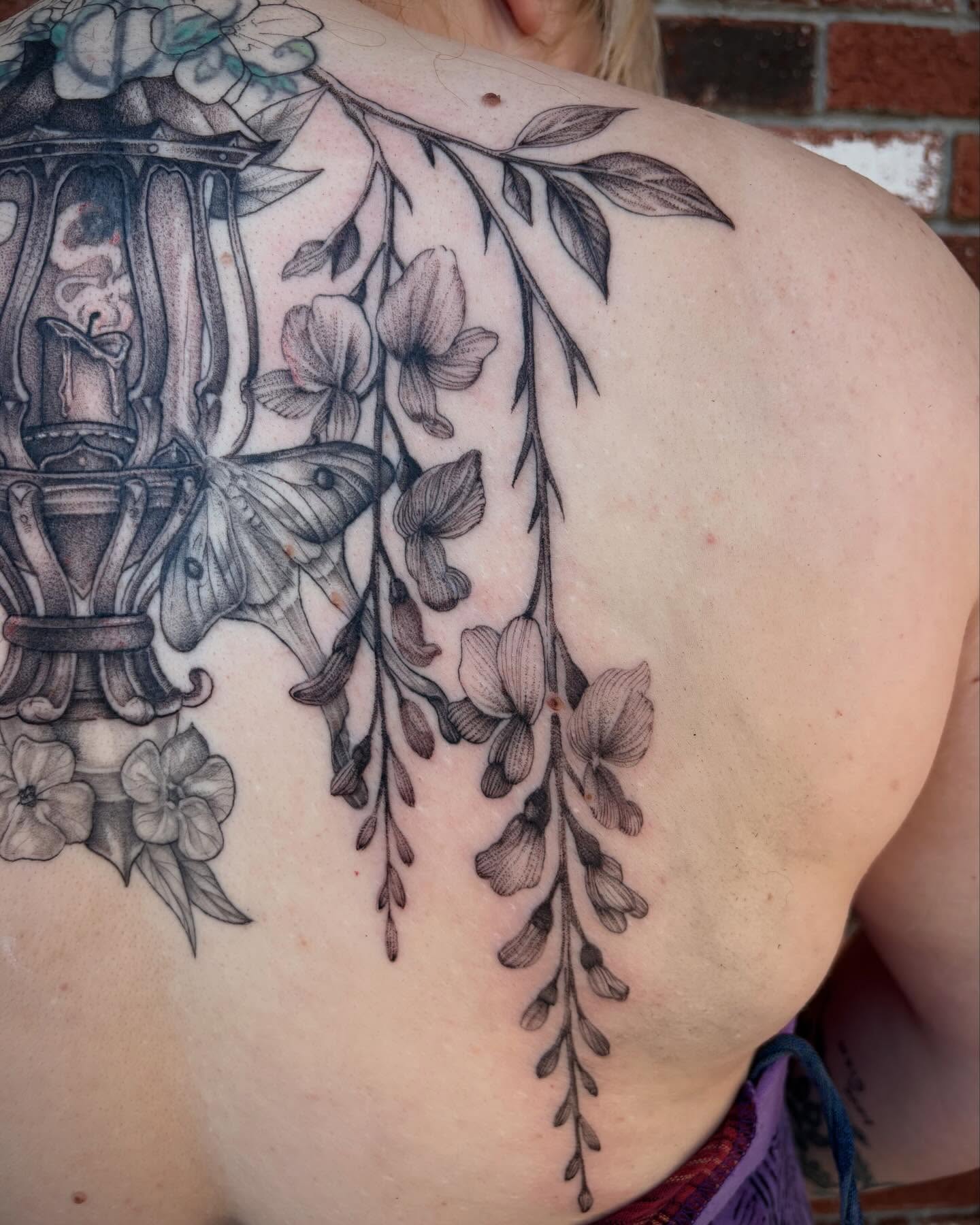 Cherry blossoms and moth realism tattoo on the shoulder by Emily Falkowski