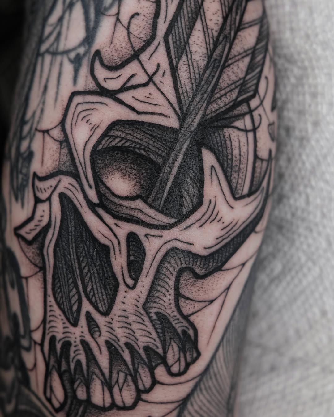Skull dotwork tattoo on the forearm by Kyle Patrick