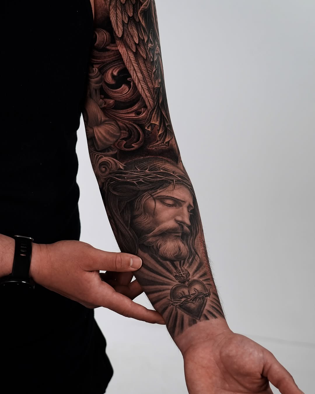 Jesus Christ and Sacred Heart realism tattoo on the forearm by Enrique Martinez