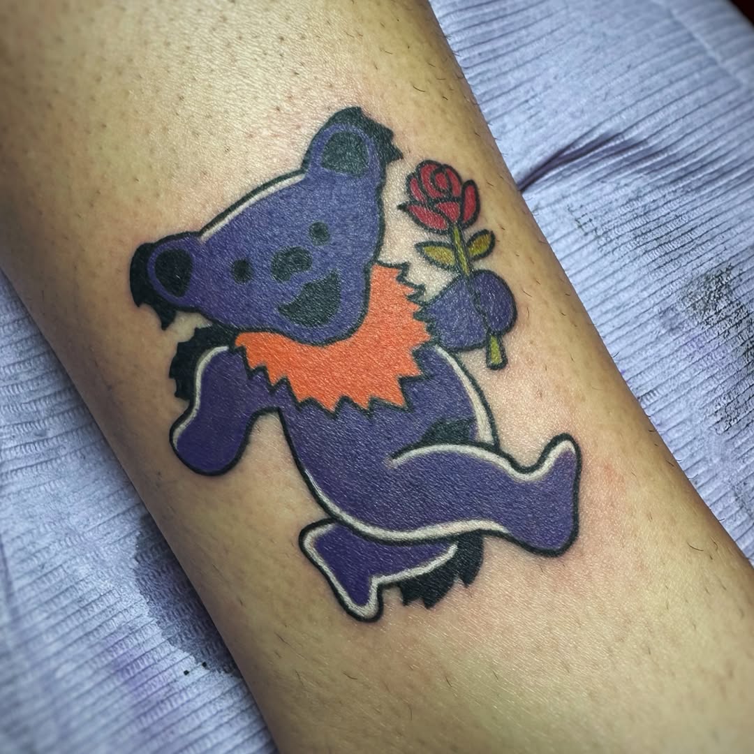 Grateful dead dancing bear with rose new school tattoo on the forearm by Anthony Guido
