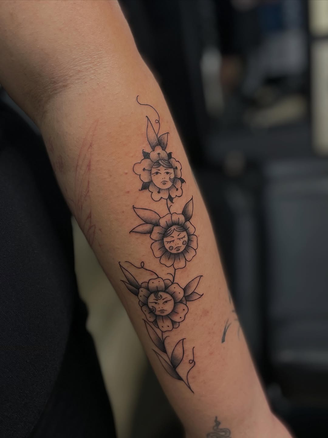 Flowers with faces surrealism tattoo on the forearm by ꧁༺𝔅𝔦𝔤 ℭ𝔥𝔲𝔫𝔤𝔲𝔷༻꧂, San Diego, California