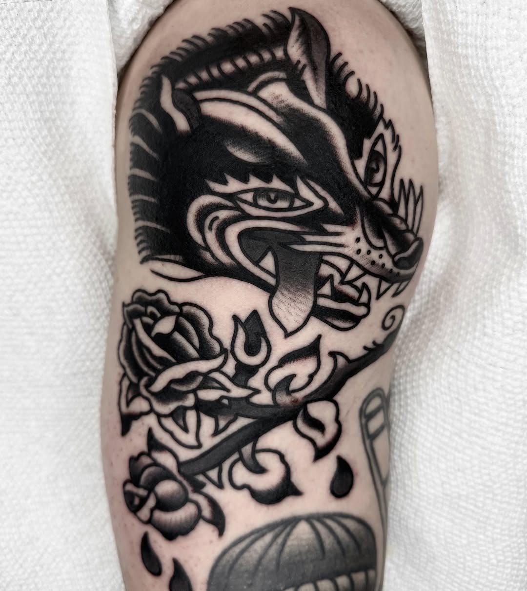 Wolf and roses American traditional tattoo on the forearm by لا Kenny McCabe لا