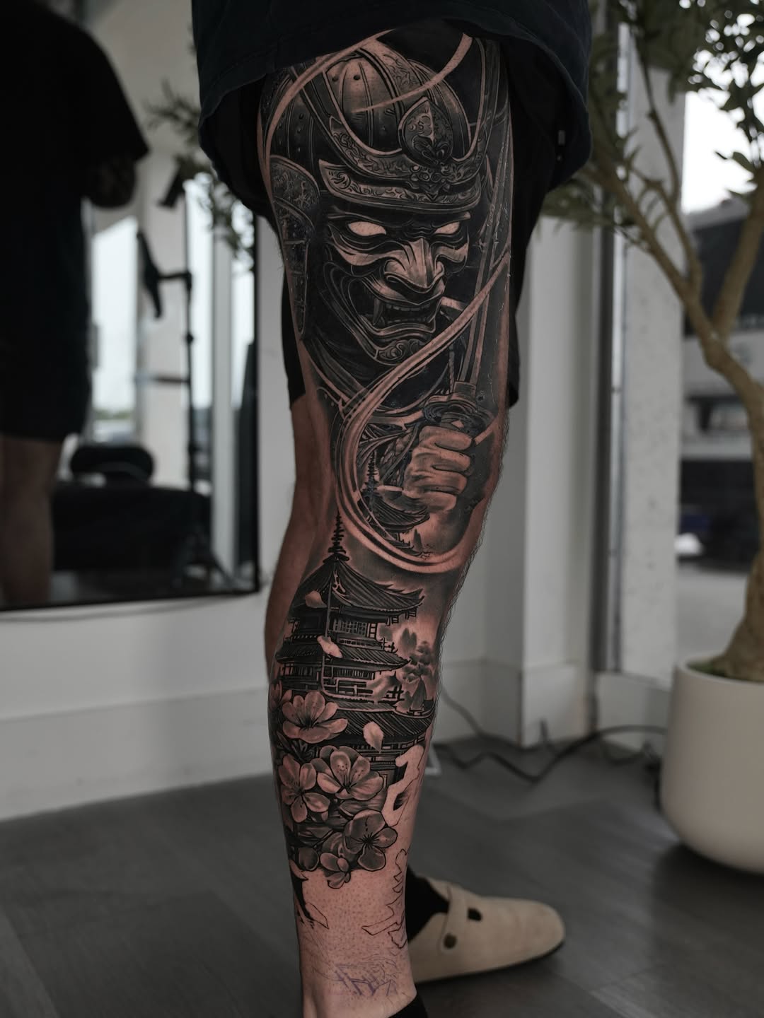 Samurai mask and pagoda realism tattoo on the calf by Luis Manuel Olivera, North Miami, Florida