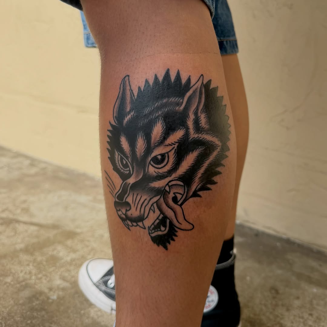Wolf head realism tattoo on the thigh by savannah
