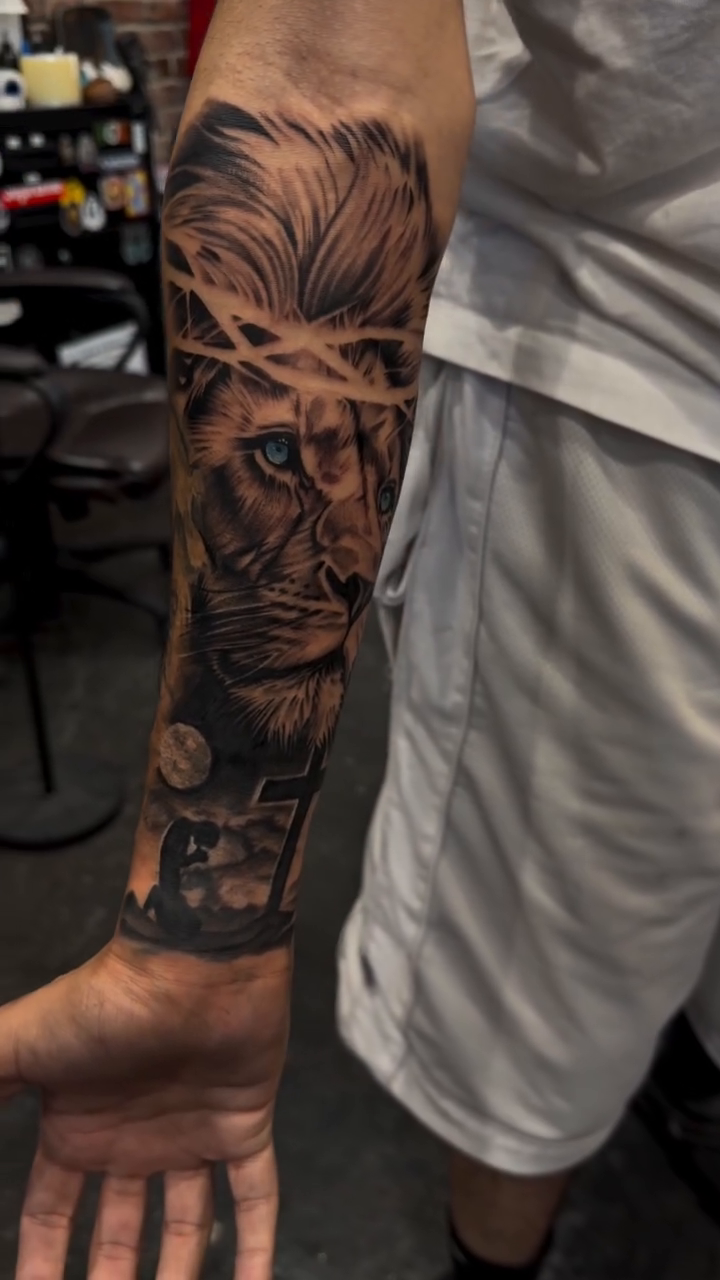 Lion with crown of thorns Chicano tattoo on the forearm by Bernie calderon, Fresno, California