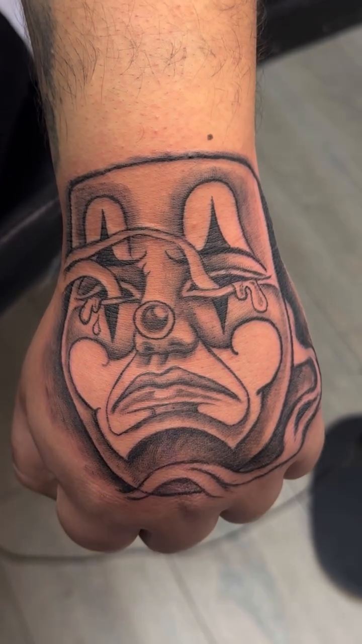 Sad clown face tattoo realism tattoo on the hand by Betotats