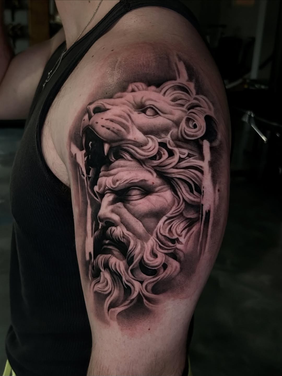Greek god with lion head surrealism tattoo on the shoulder by Dallas Corsmeier