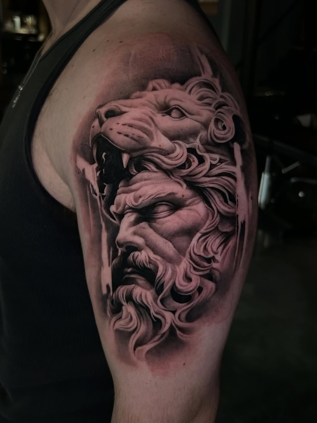 Man with lion head surrealism tattoo on the shoulder by Dallas Corsmeier