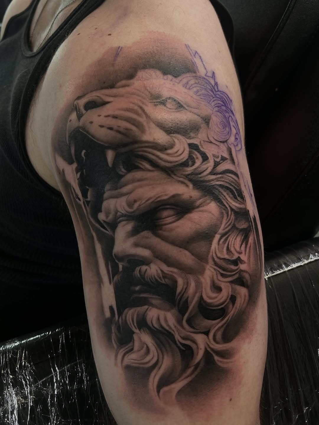 Man with lion head surrealism tattoo on the forearm by Dallas Corsmeier