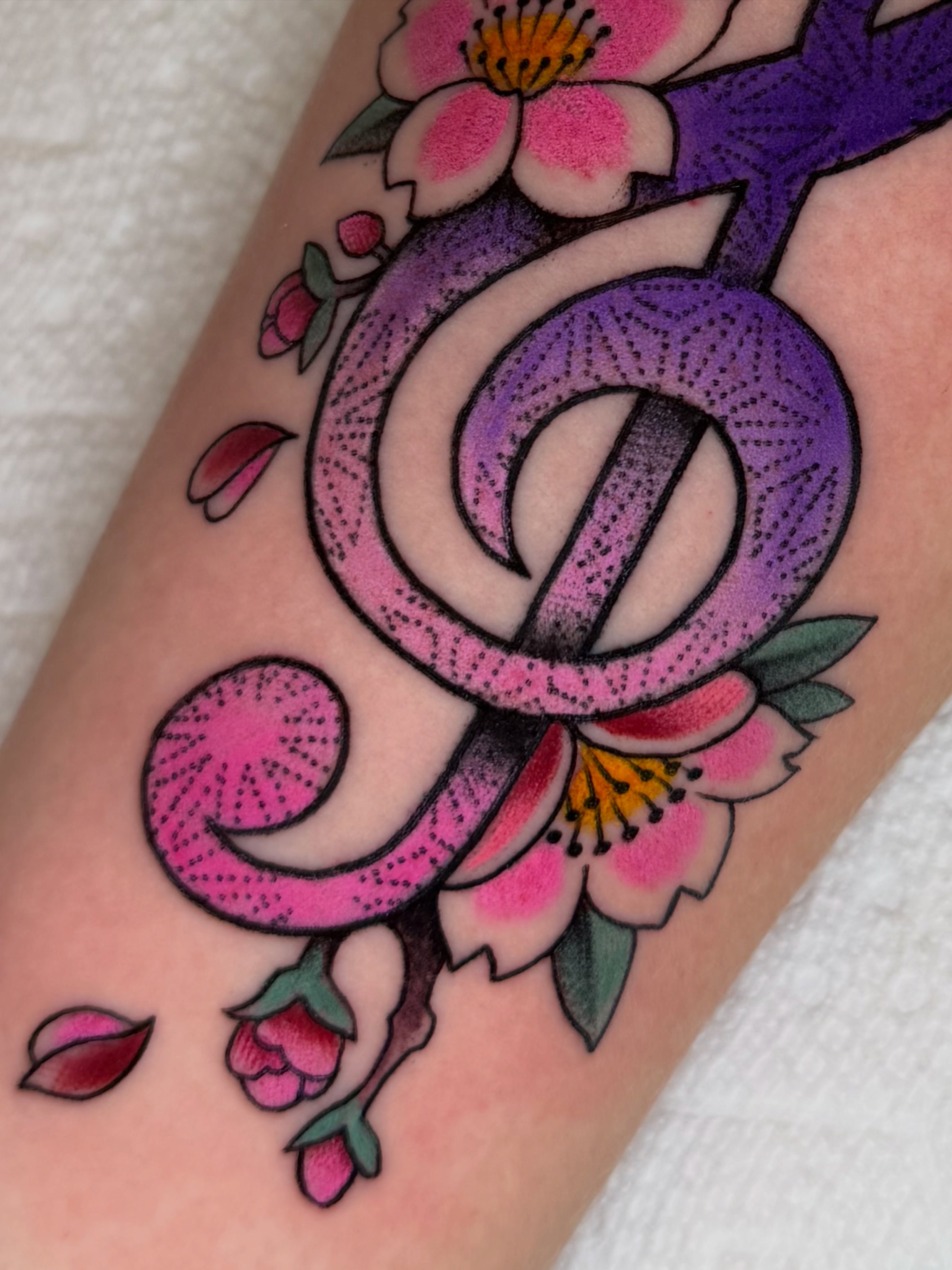 Snake and flowers American traditional tattoo on the forearm by Kevin R. Onley