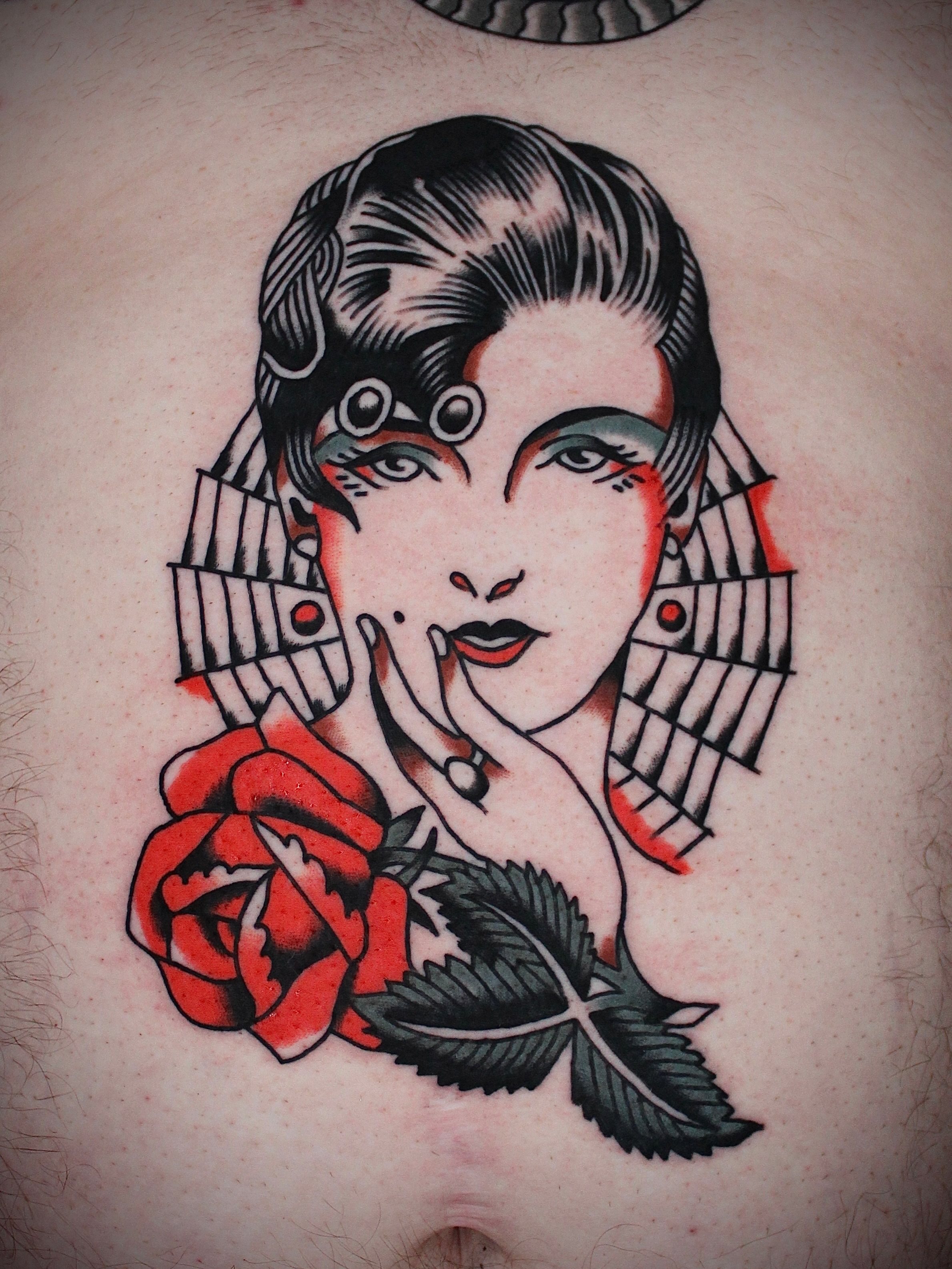 Woman with rose American traditional tattoo on the chest by Dustin Stemen, Charlotte, North Carolina
