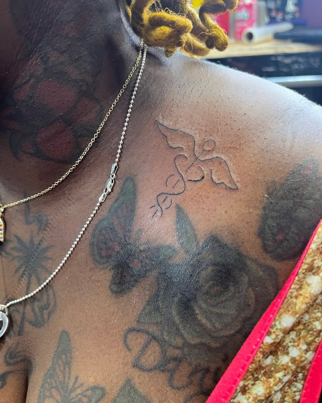 Caduceus symbol blackwork tattoo on the chest by Tatts by Quan
