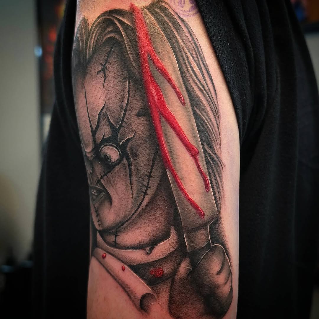 Chucky doll with knife realism tattoo on the forearm by Danielle Elizabeth