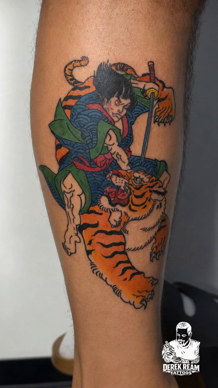Samurai fighting a tiger Japanese tattoo on the upper arm by Derek Ream